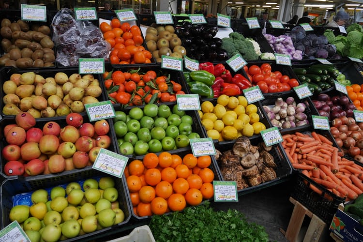 photo of produce in a food market in Oaxaca, Mexico, all in plastic tubs and looking vibrant and so delicious