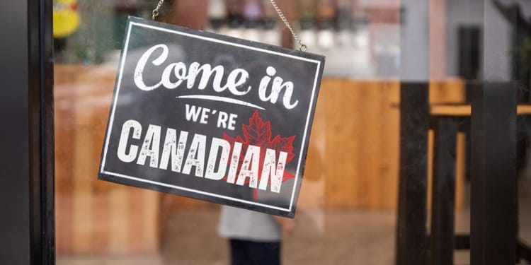 Come in! We're Canadian! sign in a door